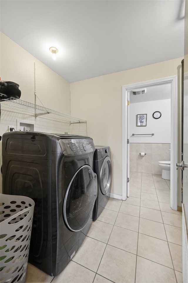 49 Raker Rd, Poughkeepsie, NY 12603 - laundry area with washer and clothes dryer and light tile patterned flooring