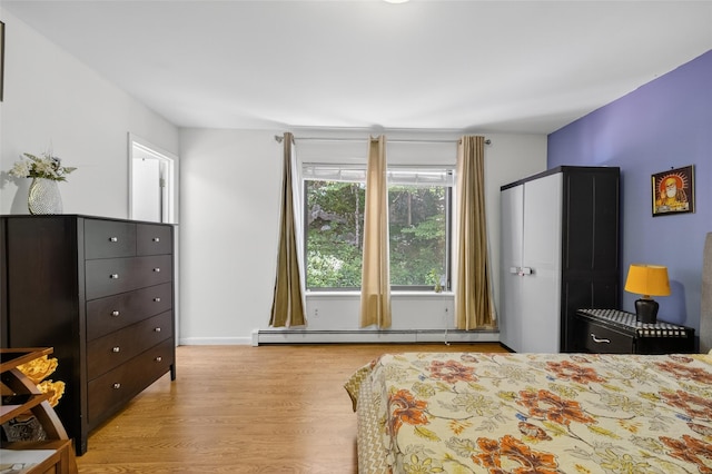 49 Raker Rd, Poughkeepsie, NY 12603 - bedroom featuring a baseboard heating unit and wood finished floors