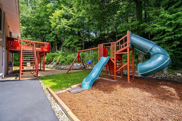 49 Raker Rd, Poughkeepsie, NY 12603 - view of playground with stairs, view of wooded area, and a deck