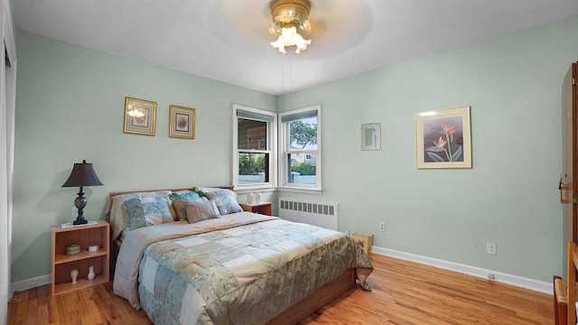 2334 Belmont Ave, Elmont, NY 11003 - bedroom with radiator and light wood-style floors