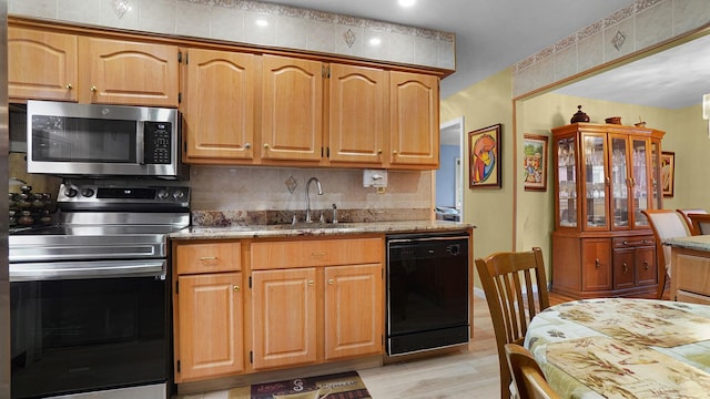 2334 Belmont Ave, Elmont, NY 11003 - kitchen featuring appliances with stainless steel finishes, light stone countertops, light wood finished floors, recessed lighting, and tasteful backsplash