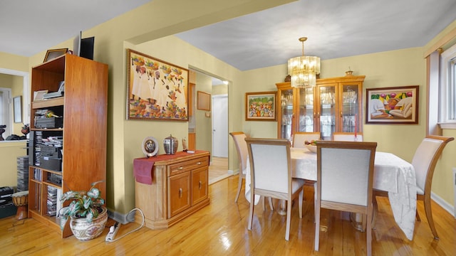 2334 Belmont Ave, Elmont, NY 11003 - dining room with light wood finished floors and a chandelier