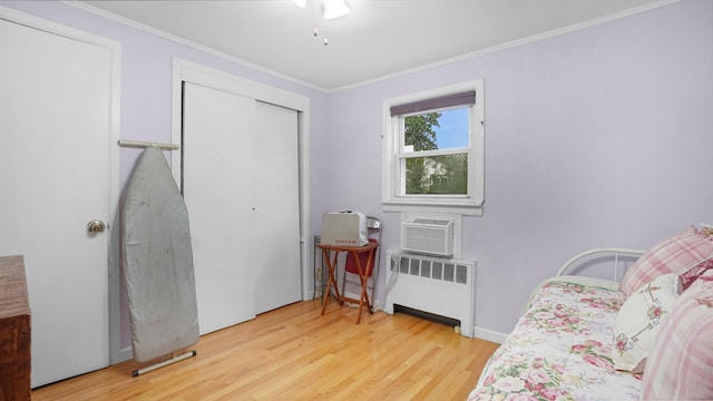 2334 Belmont Ave, Elmont, NY 11003 - bedroom featuring radiator, wood finished floors, crown molding, a closet, and cooling unit