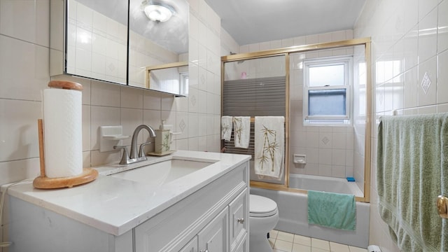 2334 Belmont Ave, Elmont, NY 11003 - full bath featuring tile walls, vanity, combined bath / shower with glass door, tile patterned floors, and backsplash