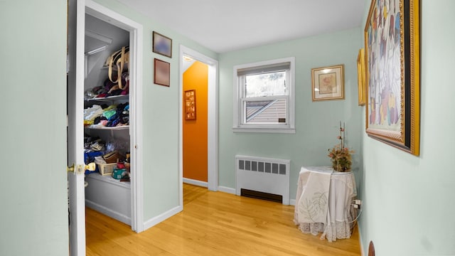 2334 Belmont Ave, Elmont, NY 11003 - hallway featuring radiator heating unit and light wood finished floors