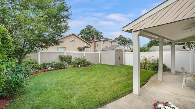 2334 Belmont Ave, Elmont, NY 11003 - fenced backyard featuring a storage unit and a patio area