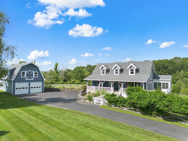 17 Conover Way, Lagrangeville, NY 12540 - view of front facade featuring a front yard, a porch, an outdoor structure, a garage, and asphalt driveway