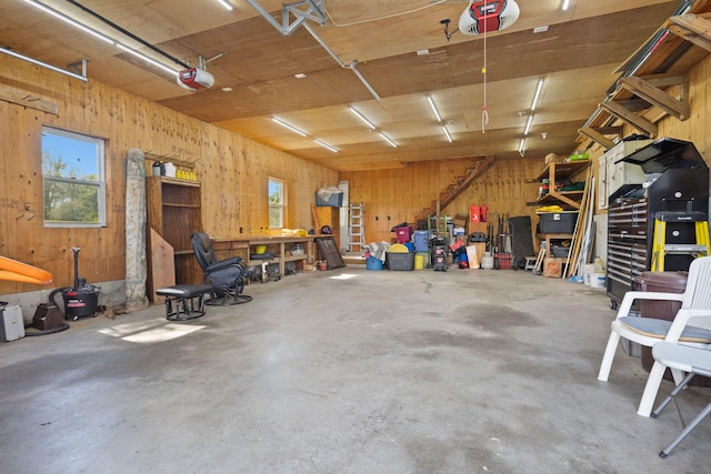 17 Conover Way, Lagrangeville, NY 12540 - garage featuring a workshop area, a garage door opener, and wooden walls