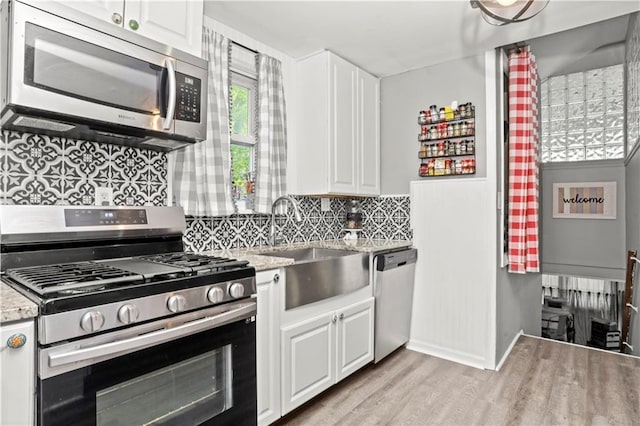 5 Orchard Dr, North Salem, NY 10560 - kitchen with stainless steel appliances, light wood-style floors, tasteful backsplash, and white cabinets