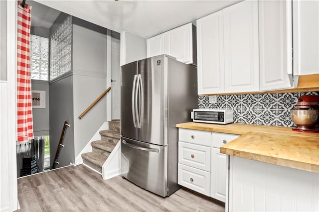 5 Orchard Dr, North Salem, NY 10560 - kitchen with butcher block countertops, freestanding refrigerator, light wood-style floors, backsplash, and white cabinetry