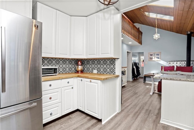 5 Orchard Dr, North Salem, NY 10560 - kitchen with freestanding refrigerator, wooden counters, backsplash, light wood-style floors, and white cabinetry