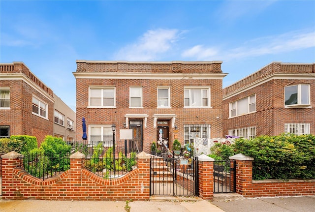 2162 24th St, Astoria, NY 11105 - view of front facade featuring a fenced front yard, a gate, and brick siding