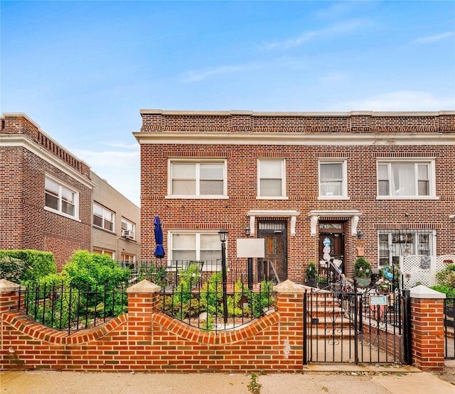 2162 24th St, Astoria, NY 11105 - view of front of home with brick siding, a fenced front yard, and a gate