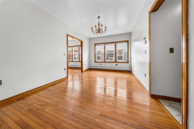 2162 24th St, Astoria, NY 11105 - unfurnished room featuring light wood-type flooring, a chandelier, and a baseboard heating unit