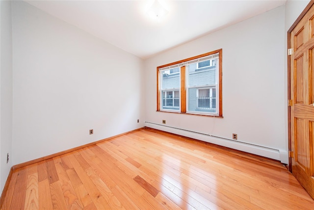2162 24th St, Astoria, NY 11105 - unfurnished room with baseboard heating and light wood-style floors