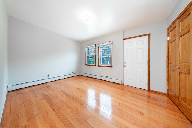 2162 24th St, Astoria, NY 11105 - unfurnished bedroom featuring light wood-style floors and a baseboard heating unit