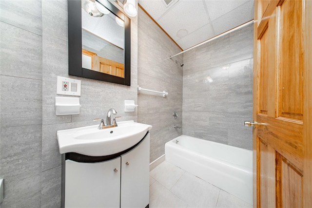 2162 24th St, Astoria, NY 11105 - full bathroom featuring vanity, shower / washtub combination, tile patterned floors, and tile walls