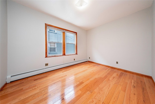 2162 24th St, Astoria, NY 11105 - spare room with a baseboard heating unit and hardwood / wood-style flooring