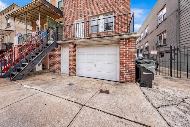 2162 24th St, Astoria, NY 11105 - view of side of home featuring brick siding, a garage, driveway, and stairway