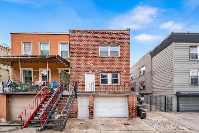 2162 24th St, Astoria, NY 11105 - multi unit property with brick siding, an attached garage, concrete driveway, covered porch, and stairs