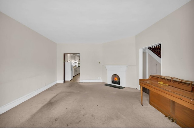 29 William St, Ossining, NY 10562 - unfurnished living room featuring carpet and a fireplace with flush hearth
