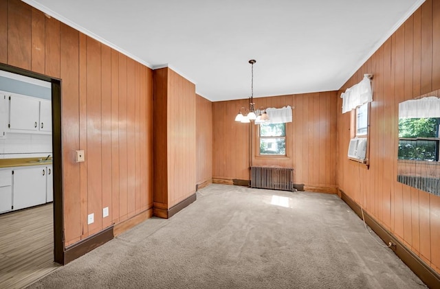 29 William St, Ossining, NY 10562 - unfurnished room featuring radiator, a chandelier, healthy amount of natural light, light carpet, and wooden walls