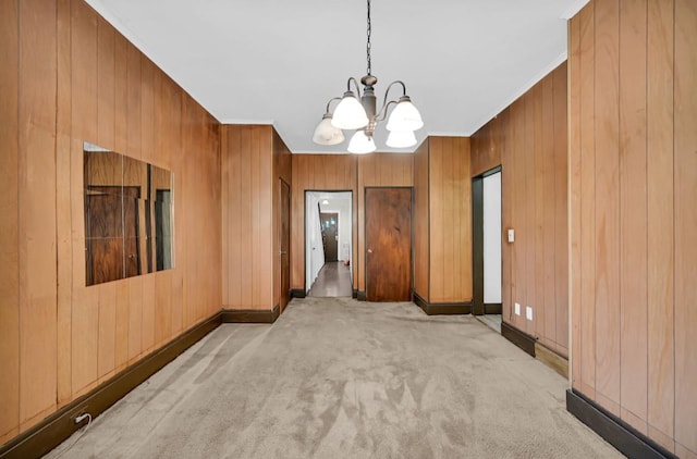 29 William St, Ossining, NY 10562 - unfurnished room with a chandelier, wood walls, light carpet, and crown molding