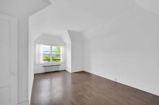 29 William St, Ossining, NY 10562 - bonus room with radiator heating unit, vaulted ceiling, and dark wood-type flooring