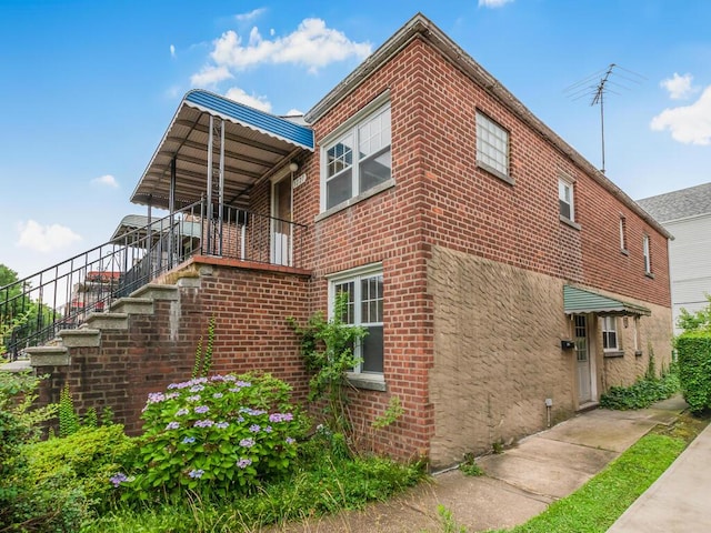 3227 Bruckner Blvd, Bronx, NY 10461 - view of property exterior featuring brick siding and stairway