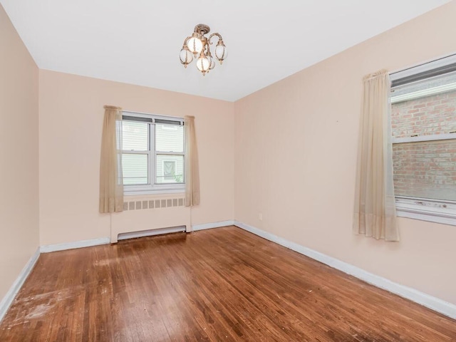3227 Bruckner Blvd, Bronx, NY 10461 - unfurnished room featuring hardwood / wood-style floors and a chandelier