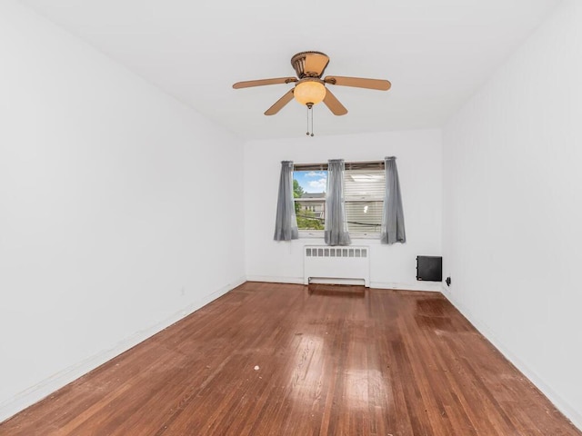 3227 Bruckner Blvd, Bronx, NY 10461 - spare room featuring radiator, wood finished floors, and ceiling fan