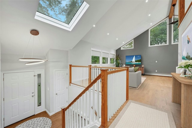 182 Arbor Crst, Somers, NY 10589 - entrance foyer with high vaulted ceiling, a baseboard heating unit, wood finished floors, and a skylight