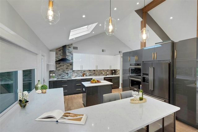 182 Arbor Crst, Somers, NY 10589 - kitchen featuring wall chimney exhaust hood, a center island, stainless steel appliances, a skylight, and high vaulted ceiling