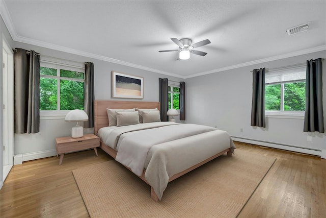 182 Arbor Crst, Somers, NY 10589 - bedroom featuring a baseboard radiator, multiple windows, light wood-style floors, and crown molding