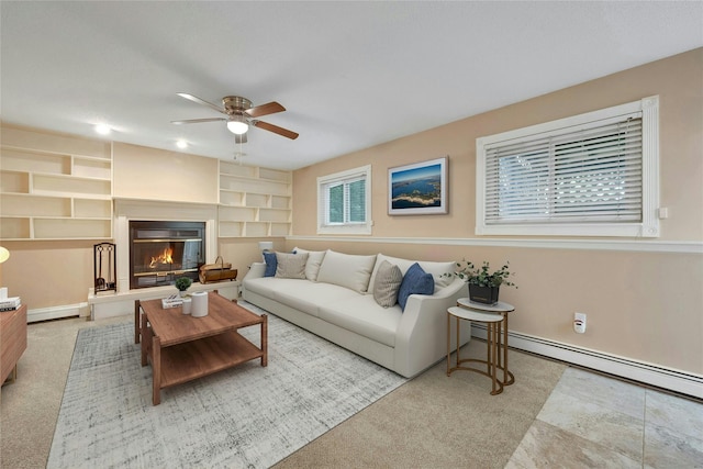 182 Arbor Crst, Somers, NY 10589 - living area featuring ceiling fan, built in shelves, a glass covered fireplace, and baseboard heating