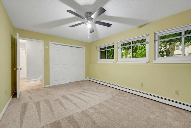 182 Arbor Crst, Somers, NY 10589 - unfurnished bedroom featuring a baseboard radiator, carpet flooring, a closet, and a ceiling fan
