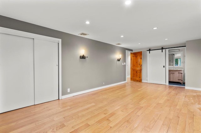 8 W Ln, South Salem, NY 10590 - unfurnished living room with a barn door, light wood-type flooring, and recessed lighting