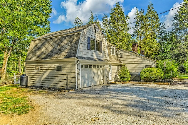 8 W Ln, South Salem, NY 10590 - view of side of home with a gambrel roof, driveway, an attached garage, and roof with shingles