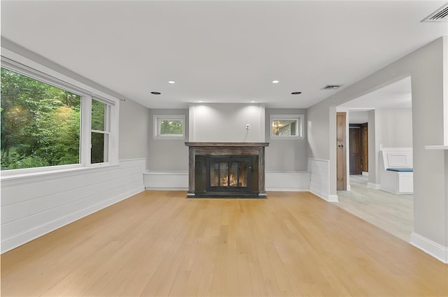 8 W Ln, South Salem, NY 10590 - unfurnished living room featuring a glass covered fireplace, light wood-style flooring, wainscoting, and recessed lighting