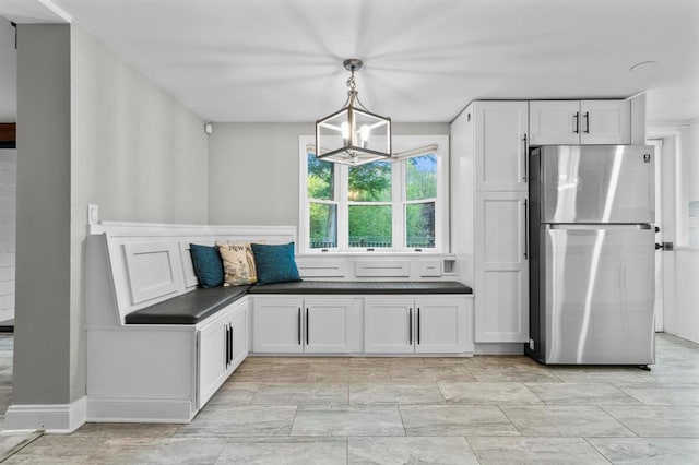 8 W Ln, South Salem, NY 10590 - kitchen with freestanding refrigerator, dark countertops, white cabinetry, a chandelier, and pendant lighting