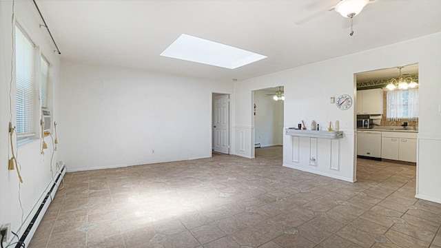 70 Wilson Ave, Mastic Beach, NY 11951 - unfurnished living room featuring a baseboard radiator, a ceiling fan, and a skylight
