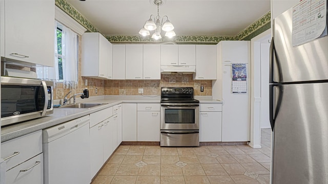 70 Wilson Ave, Mastic Beach, NY 11951 - kitchen with appliances with stainless steel finishes, under cabinet range hood, light countertops, and white cabinets