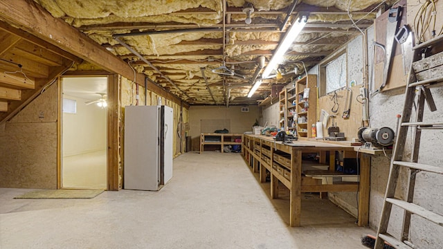 70 Wilson Ave, Mastic Beach, NY 11951 - unfinished basement with freestanding refrigerator and a workshop area
