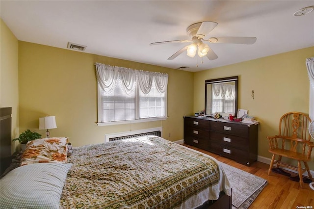 121 6th St, Hicksville, NY 11801 - bedroom featuring an AC wall unit, wood finished floors, and ceiling fan