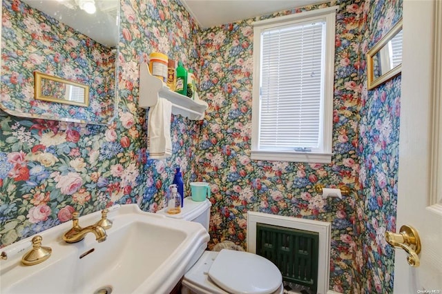 121 6th St, Hicksville, NY 11801 - half bathroom with wallpapered walls and radiator heating unit
