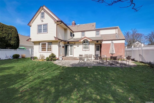 121 6th St, Hicksville, NY 11801 - rear view of house featuring a fenced backyard, a chimney, and a patio
