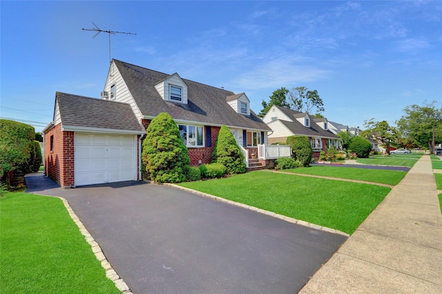 31 Amby Ave, Plainview, NY 11803 - cape cod house with brick siding, a garage, driveway, a front lawn, and roof with shingles