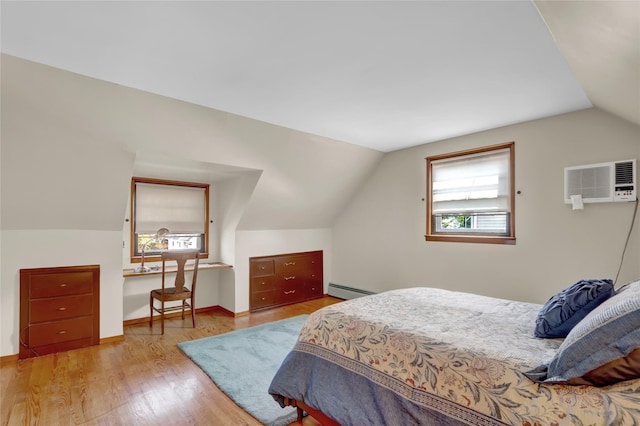 31 Amby Ave, Plainview, NY 11803 - bedroom with a wall unit AC, vaulted ceiling, a baseboard heating unit, and wood finished floors