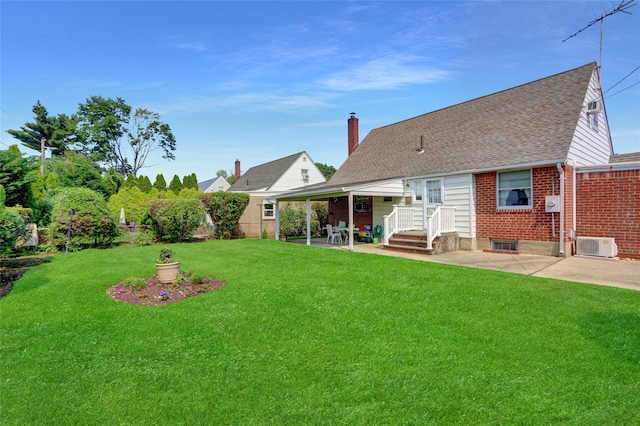 31 Amby Ave, Plainview, NY 11803 - back of property with a patio area, brick siding, a chimney, and a shingled roof