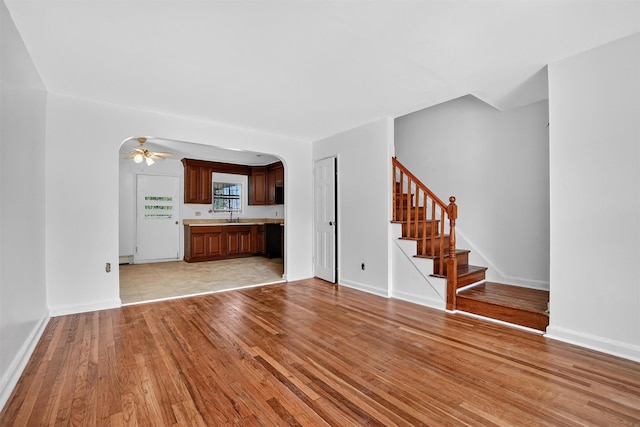 1025 E 229th St Unit B, Bronx, NY 10466 - unfurnished living room featuring light wood-style flooring, arched walkways, stairs, and a ceiling fan